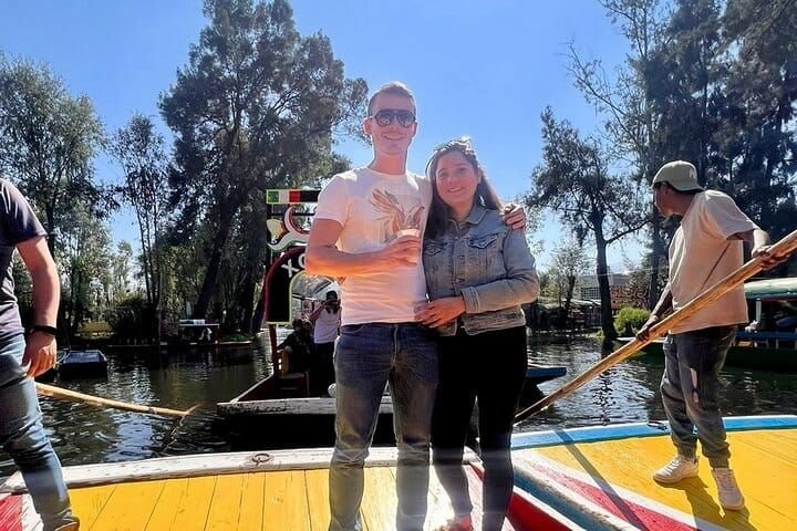 A couple with drinks on board while the boatman poles past