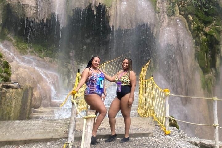 Water falls over the entrance to the caves