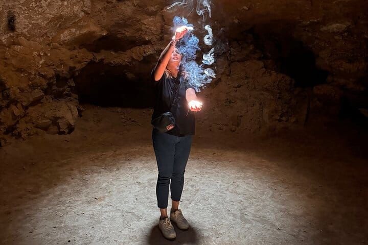 Sparkler light painting inside the cave, smoke rising in the beam