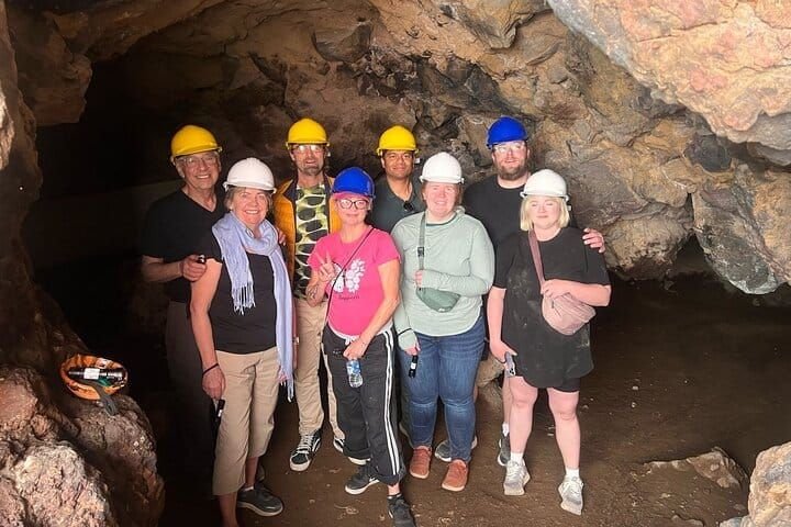 The full group in helmets inside the cave