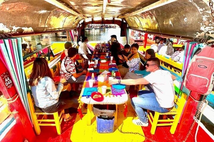 Inside the trajinera, the group gathered around the long table